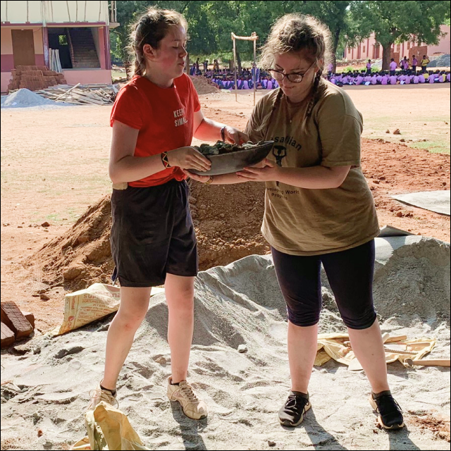 Girls on their projects, building a school